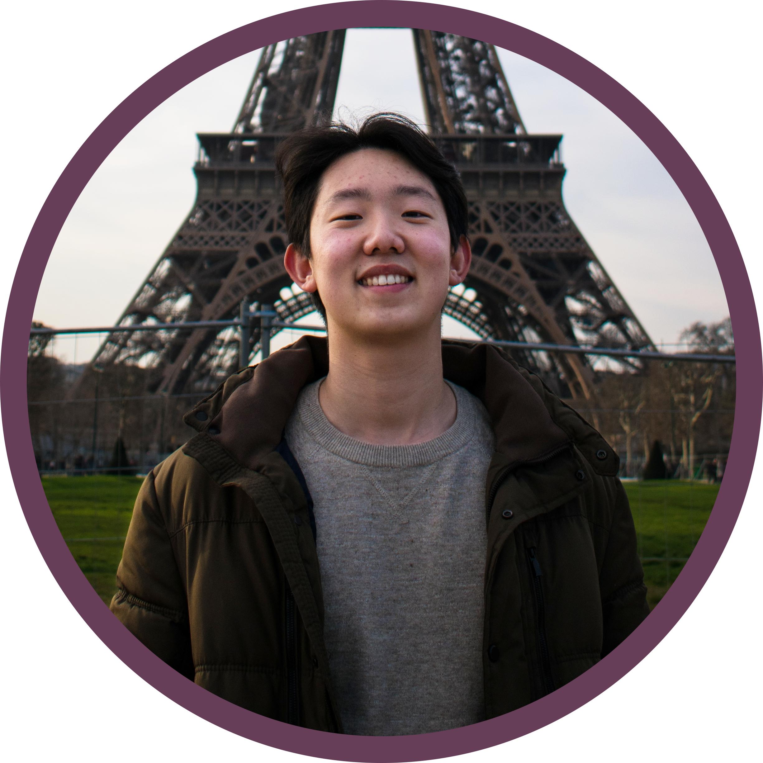 Kenneth smiling in front of the Eiffel Tower